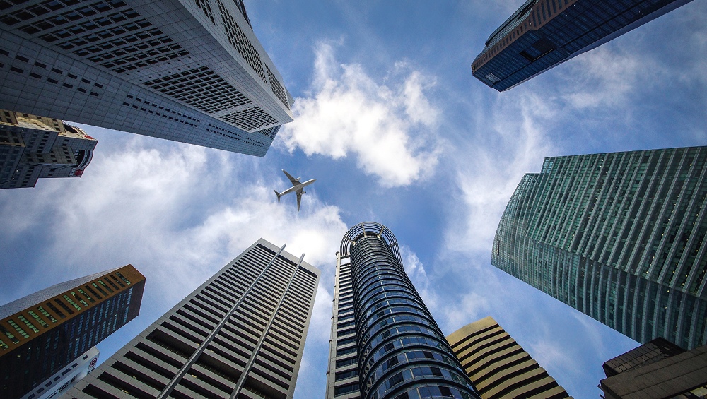 Skyscrapers with airplane flying between buildings