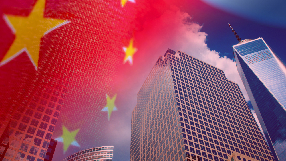 Double exposure of the Chinese flag (red with yellow stars) overlaid on modern American skyscrapers (including One World Trade Center).