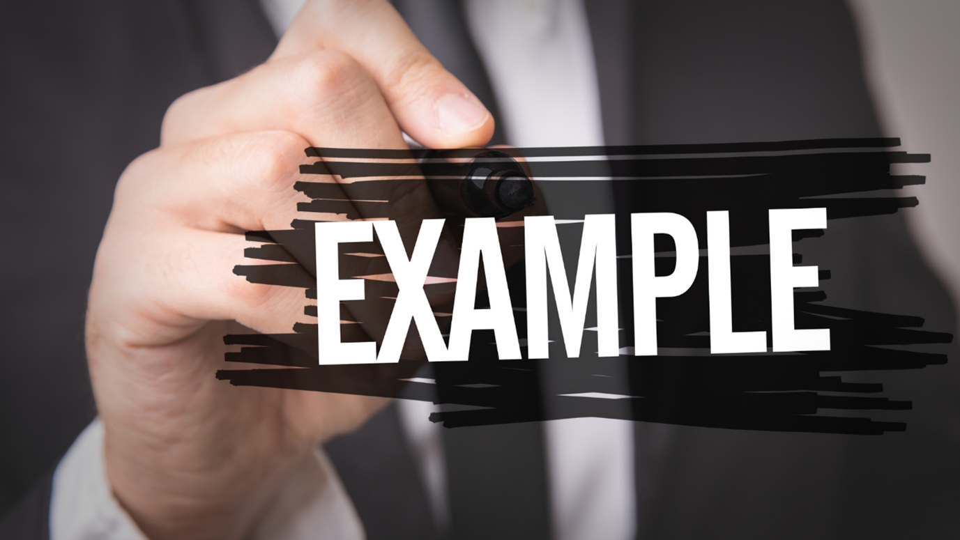 A hand holding a marker, writing the word "EXAMPLE" in white over a thick black horizontal marker stroke.