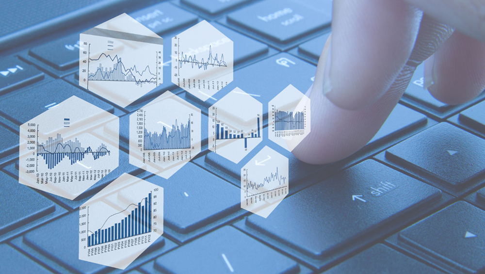 A finger pressing a computer keyboard button, overlaid with hexagonal digital windows showing various business and financial data charts and graphs.