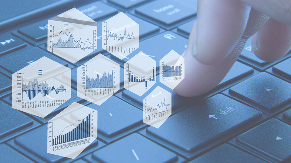 A finger pressing a computer keyboard button, overlaid with hexagonal digital windows showing various business and financial data charts and graphs.