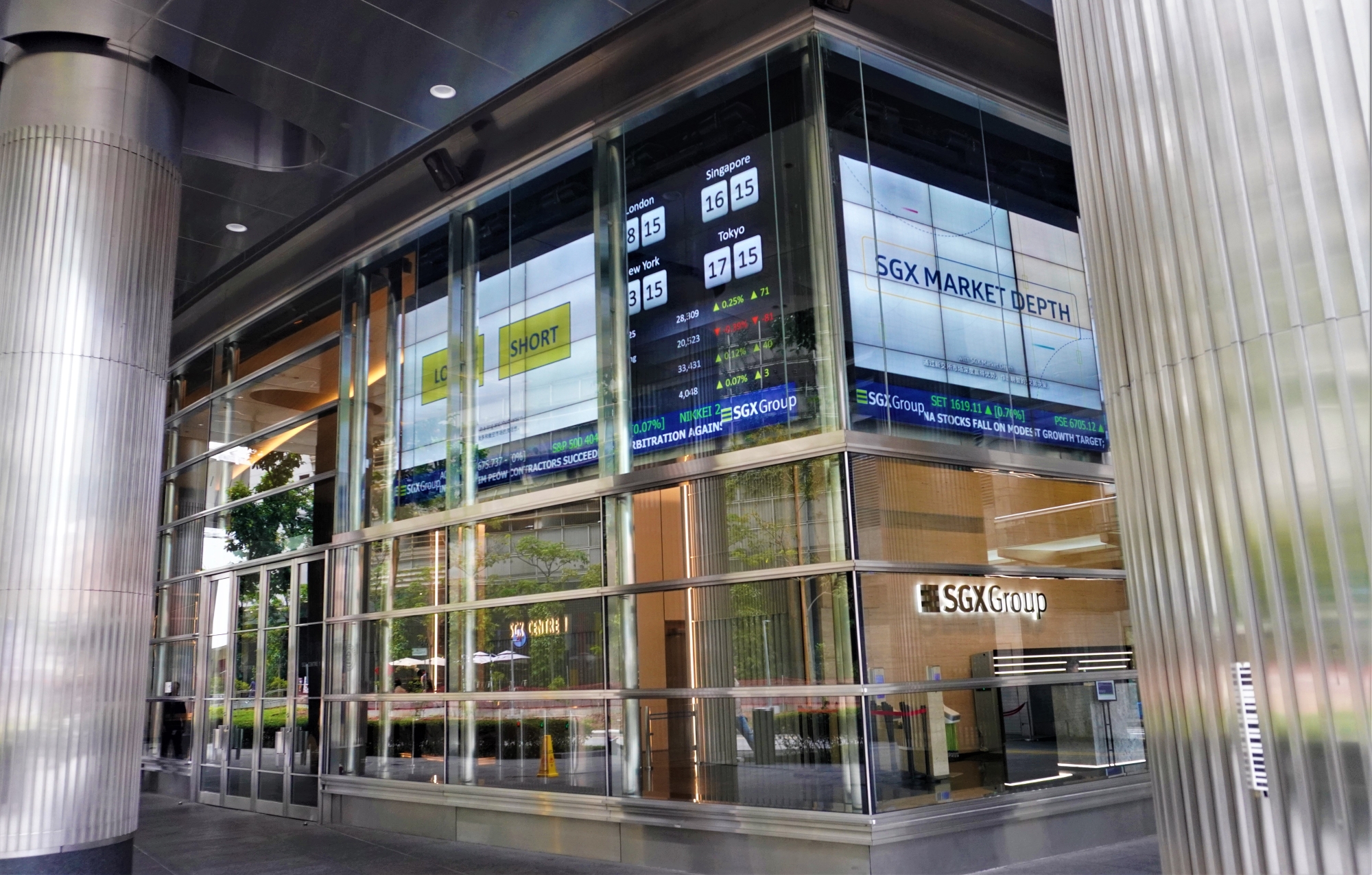 SGX Group building entrance with market depth screens and global stock indices