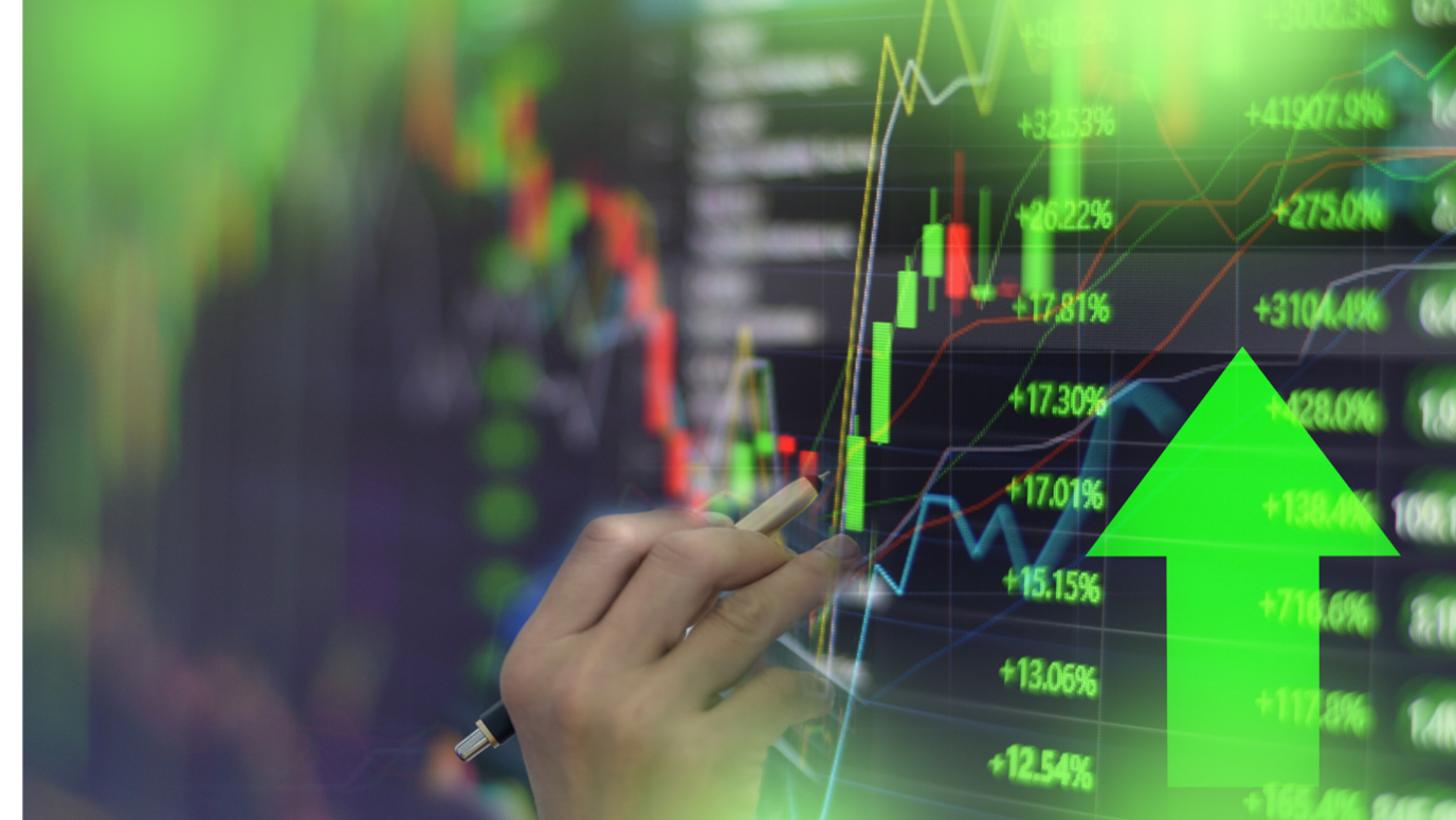 A hand pointing a pen at a bright green, glowing digital candlestick chart with an overlay of percentage increases and a large upward-pointing arrow.