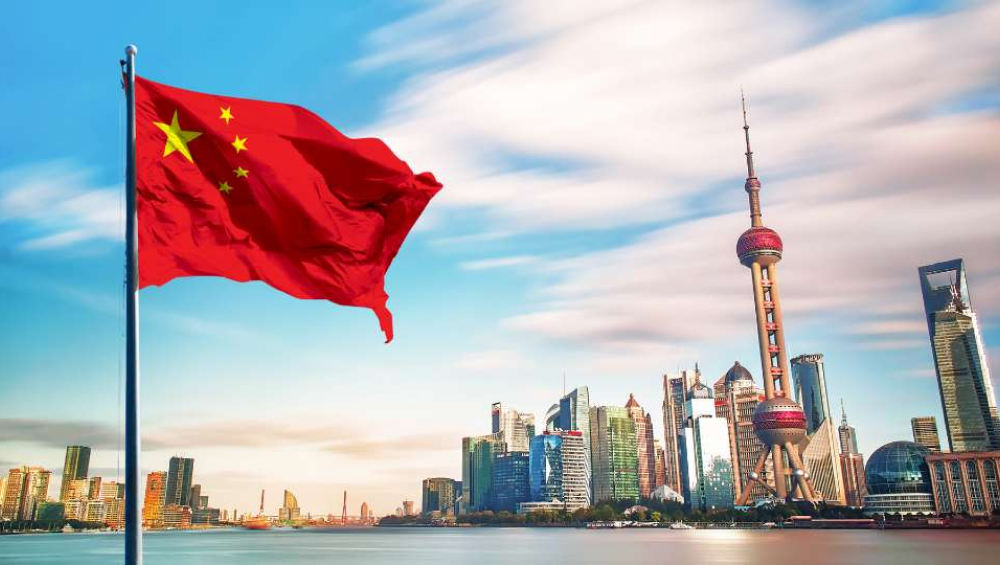 Chinese flag in front of Shanghai skyline.