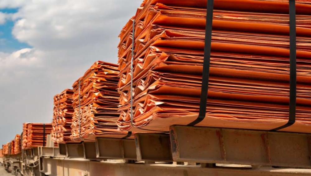 Copper cathode plates stacked on a transport platform.