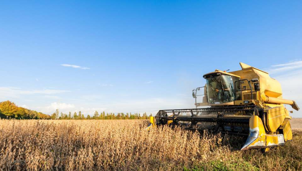 Combine harvester working in a crop field.