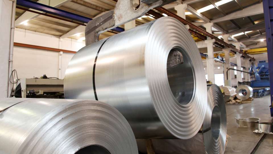 Large steel rolls in manufacturing facility