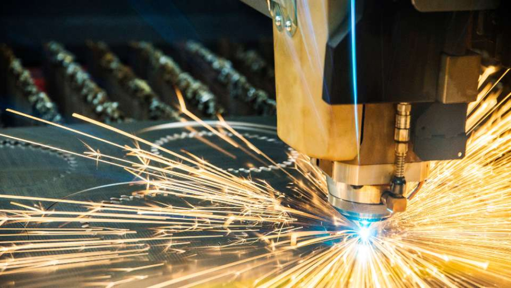Laser cutting metal with sparks.