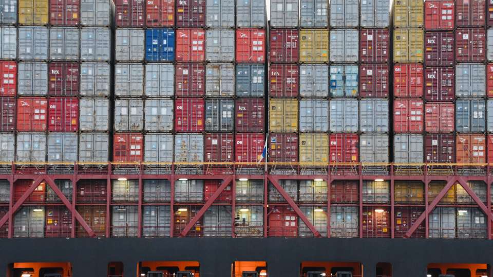 Rows of stacked shipping containers.