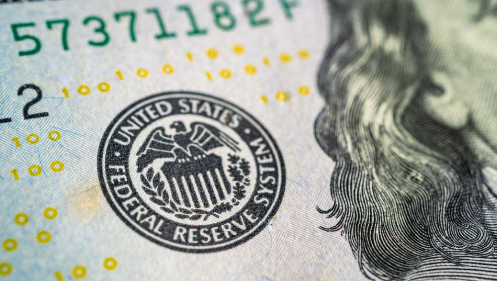 Close-up of the United States Federal Reserve System seal on a dollar bill.