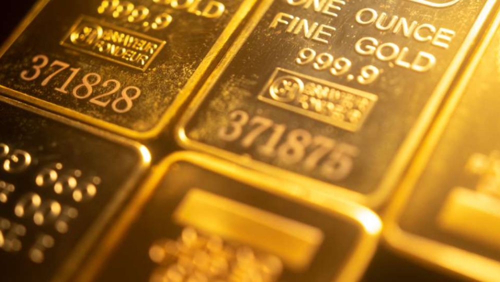 Close-up of 999.9 fine gold bullion bars with serial numbers.