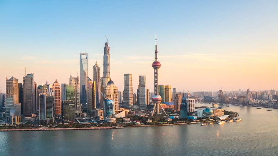 Panoramic view of Shanghai's Lujiazui financial district skyline during sunset.