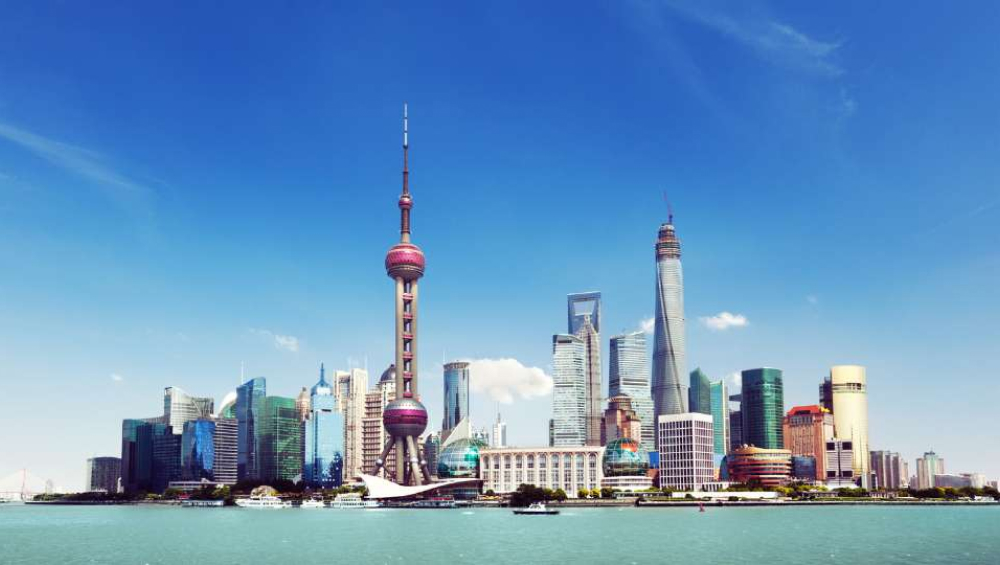 Panoramic view of the Shanghai Lujiazui skyline featuring the Oriental Pearl Tower and Shanghai Tower.