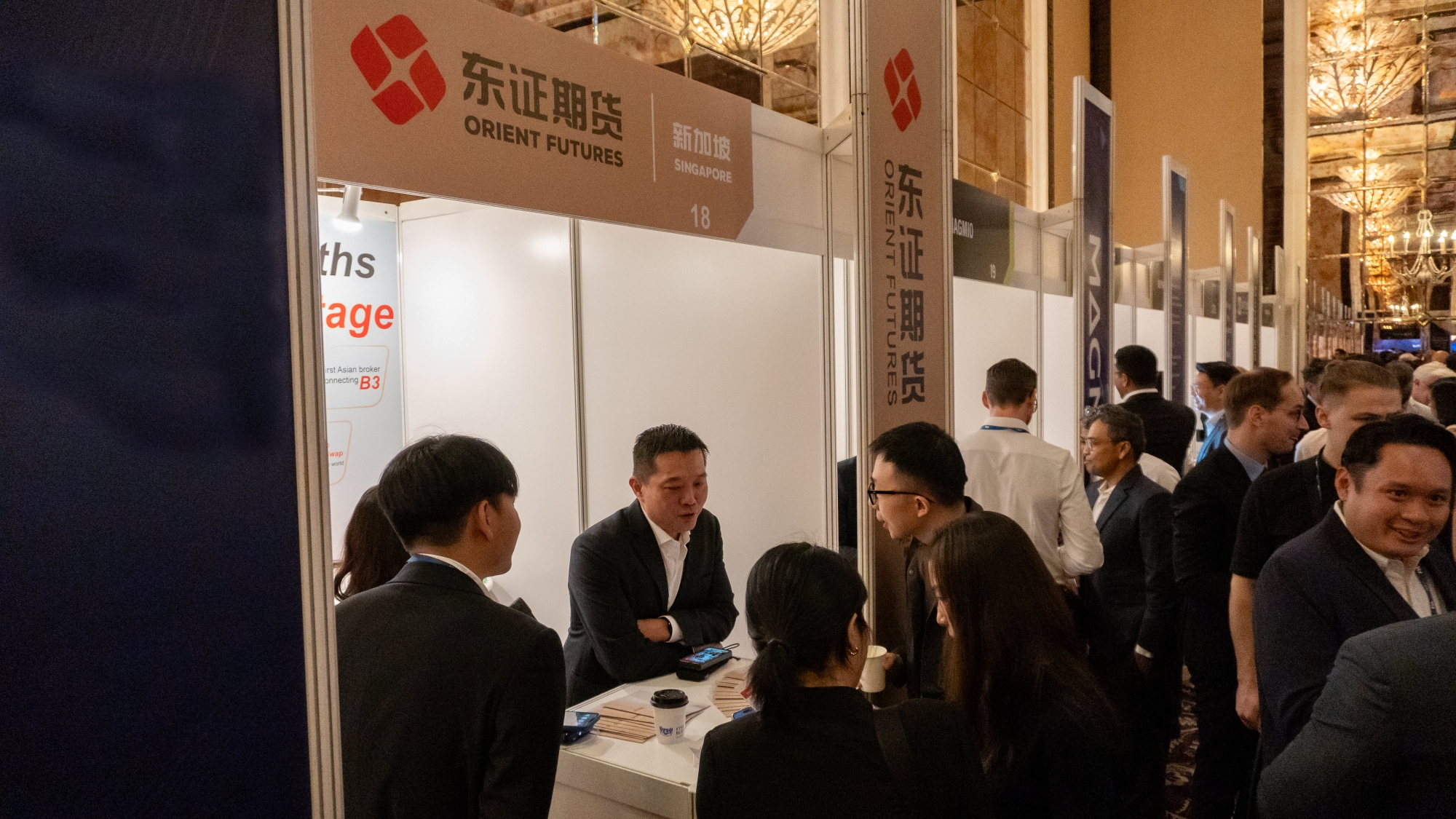 Close-up of Orient Futures Singapore CEO interacting with participants at FIA Asia 2024 booth