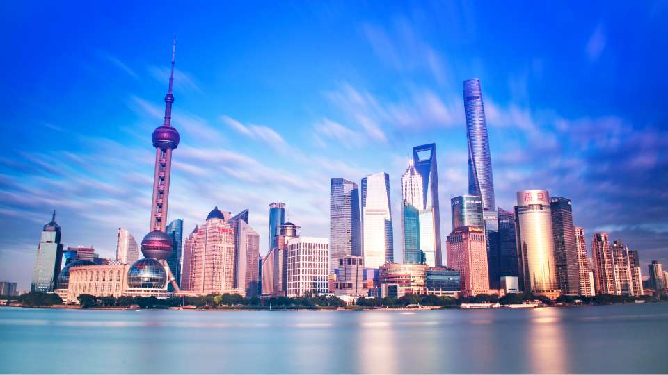 Panoramic view of the Shanghai Lujiazui skyline featuring the Oriental Pearl Tower and Shanghai Tower.