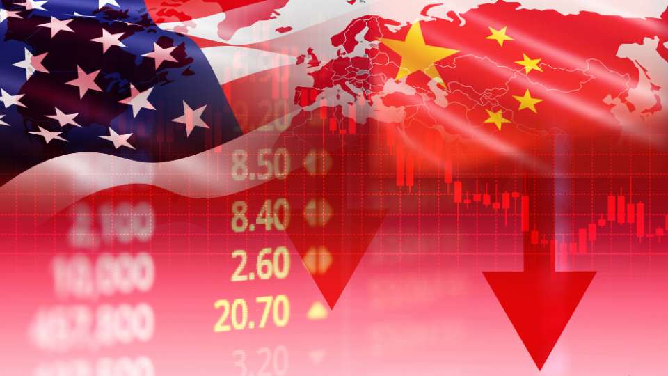 Composite image of USA and China flags overlaid with falling stock market numbers and red downward arrows.