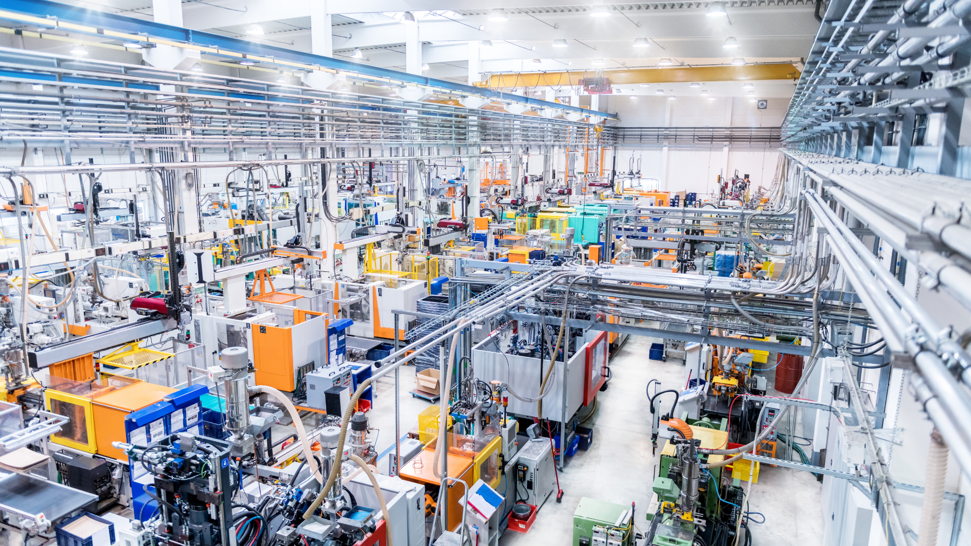 Modern automated factory with industrial machines and robotic systems producing components.