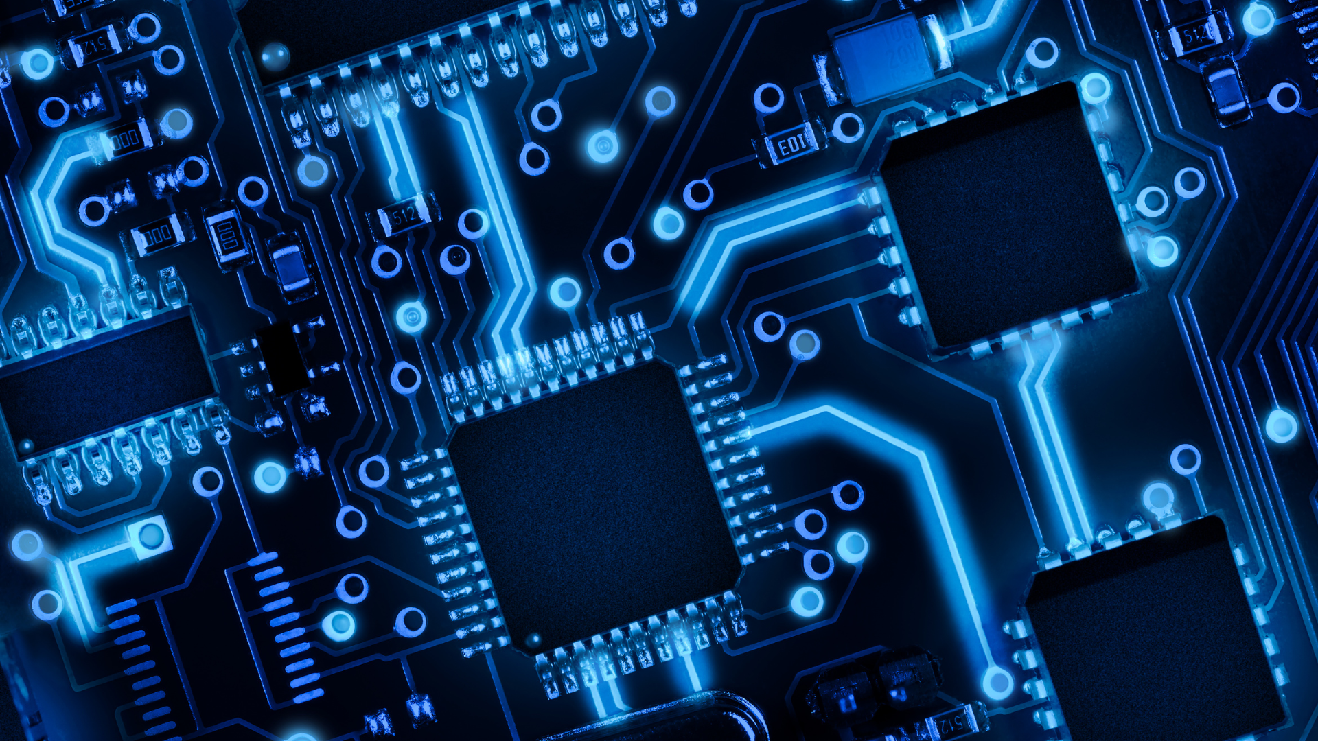 Close-up view of a glowing blue microchip and circuit board.
