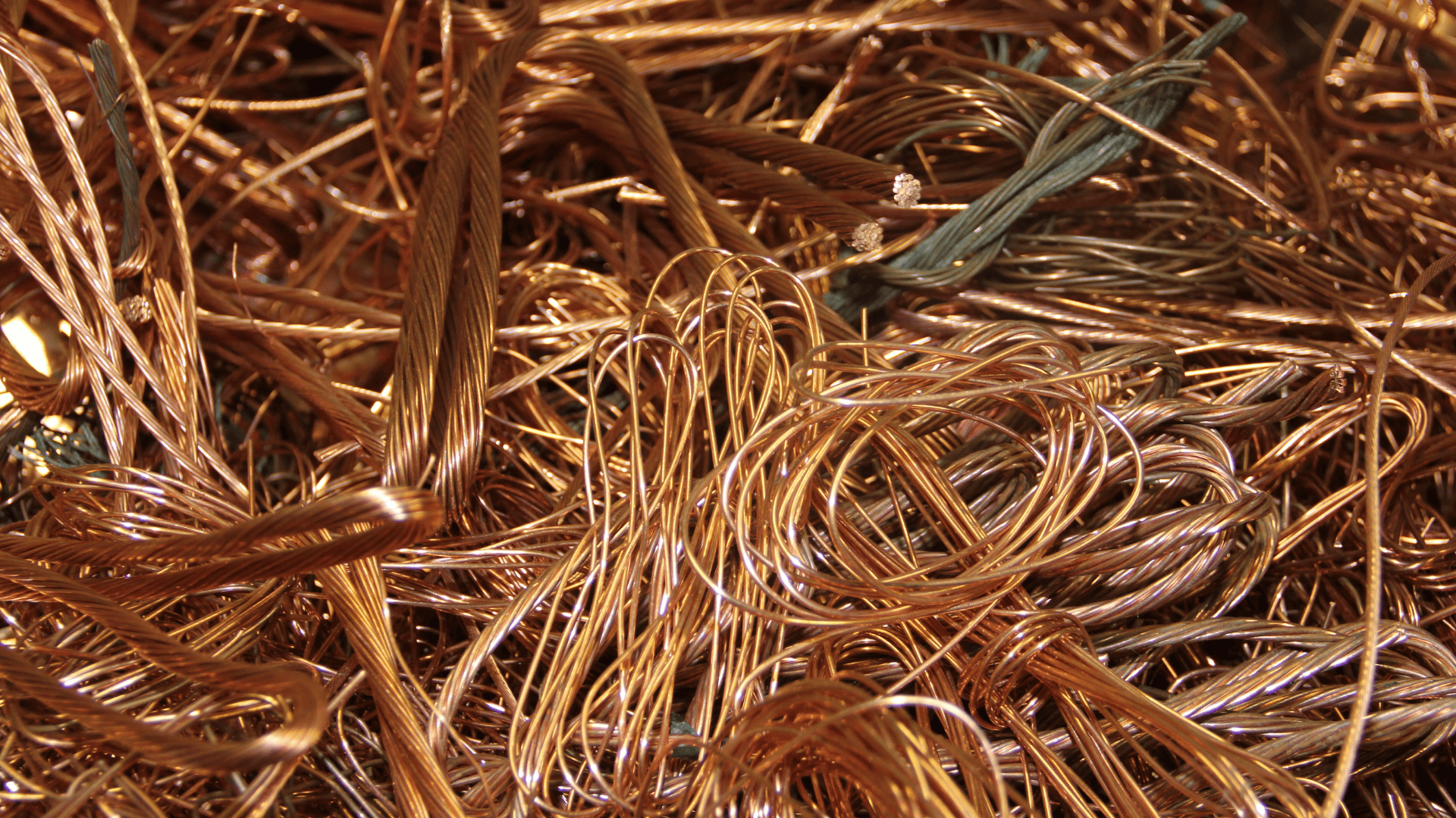 Close-up of a large pile of tangled, stripped copper wires and scrap metal.