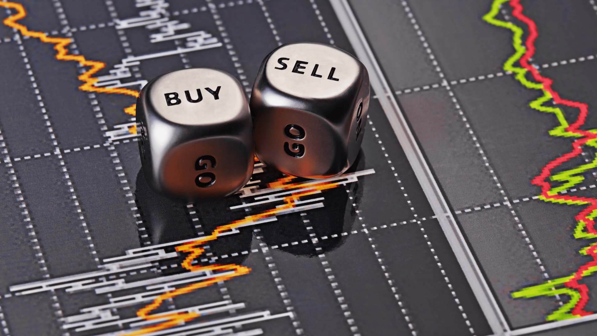 Metallic dice showing “BUY” and “SELL” placed on a stock market chart.