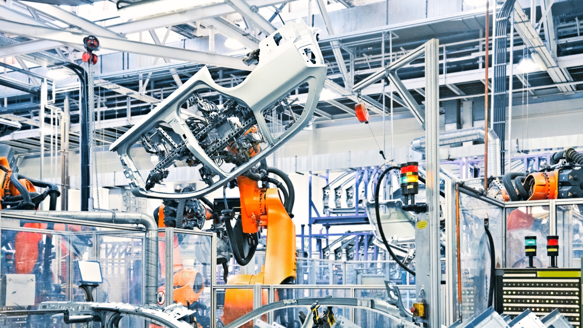 Automated industrial robots assembling car parts in a modern factory.
