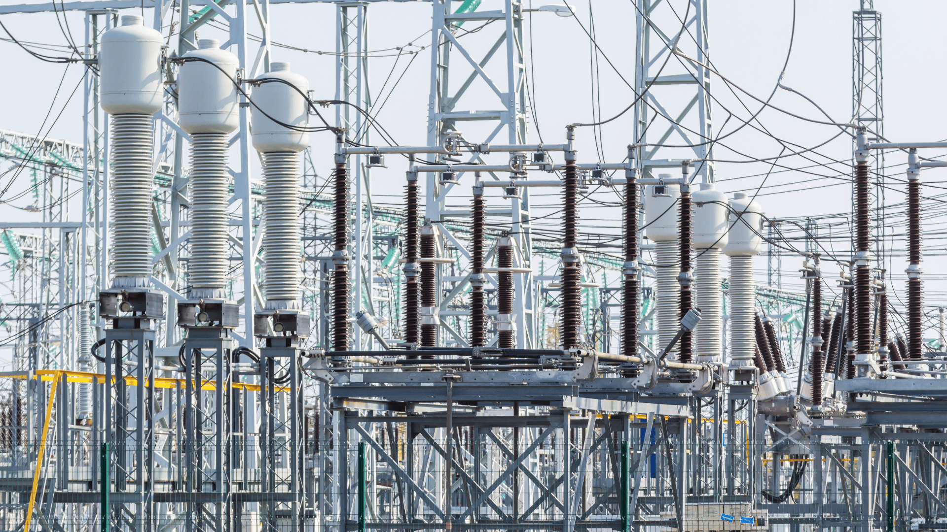 High-voltage electrical substation with transformers and power lines.