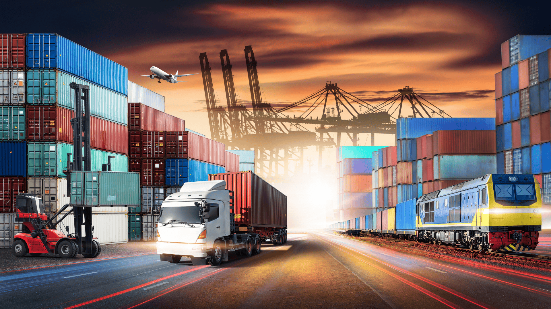 Global logistics hub with cargo containers, truck, freight train, airplane, and cranes at sunset.