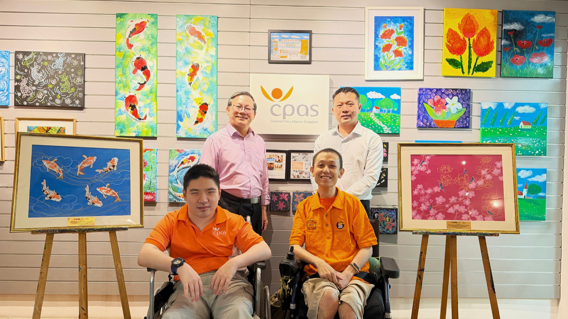 Group photo featuring Marcus Goi, CEO of Orient Futures Singapore, and Tommy Tng, Head of CPAS Goodwill, Rehabilitation and Occupational Workshop (GROW), and the GROW artists at Cerebral Palsy Alliance Singapore