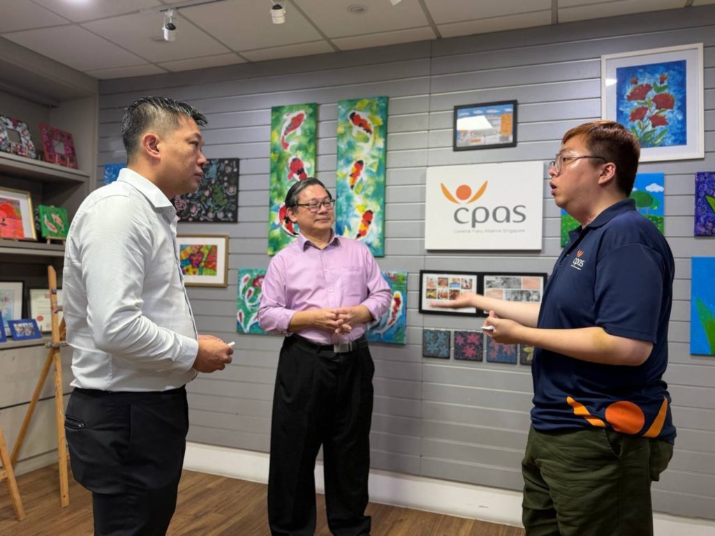 Marcus Goi, CEO of Orient Futures Singapore, interacting with representatives from Cerebral Palsy Alliance Singapore