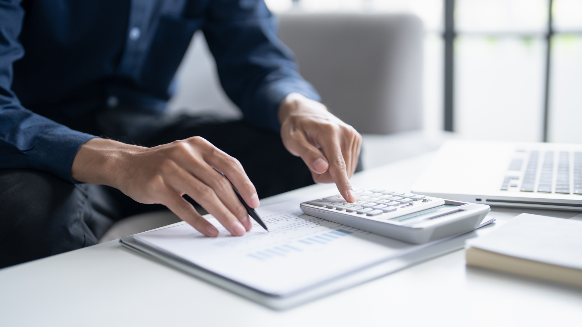 Man calculate finances home pay bills taxes on mobile phones