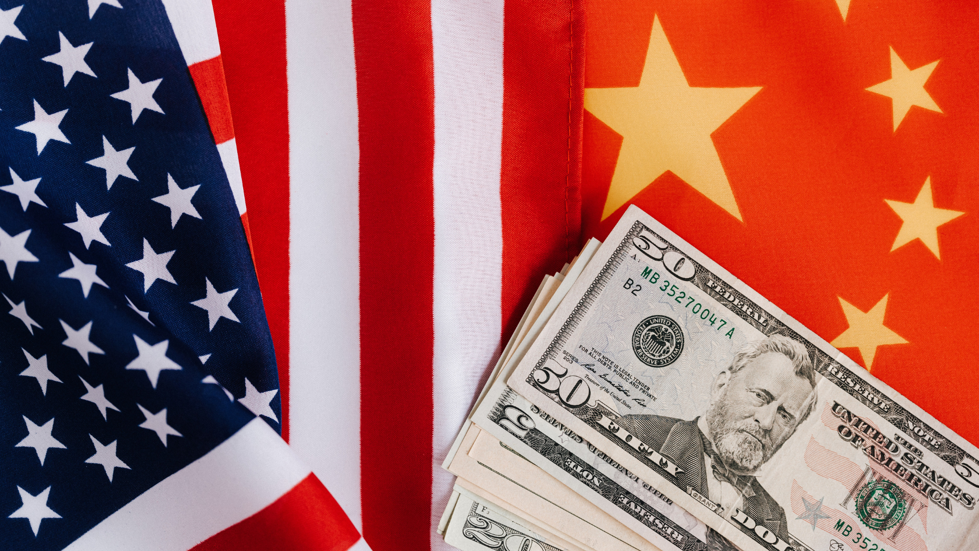 American and Chinese flags and USA dollars