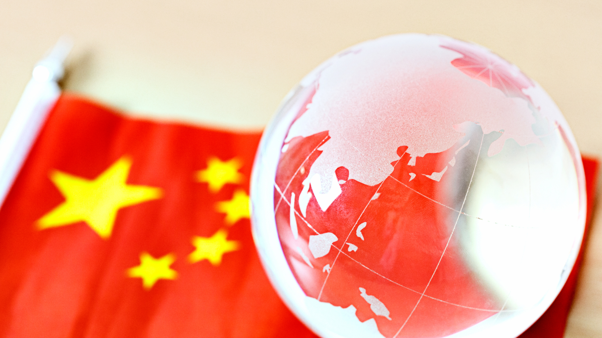Glass globe on Peoples Republic of China national flag