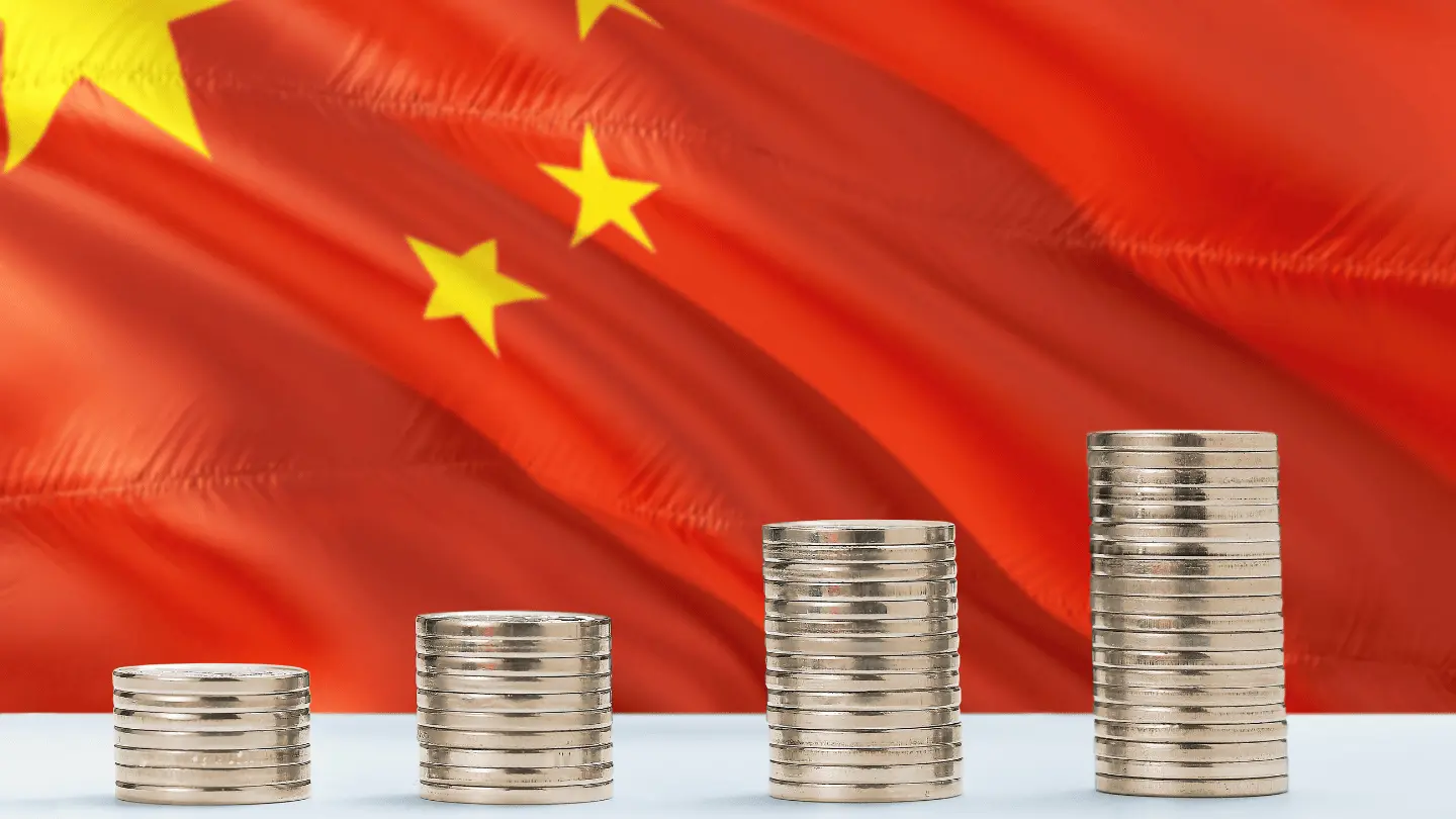 China flag waving in the background with rows of coins for finance and business concept