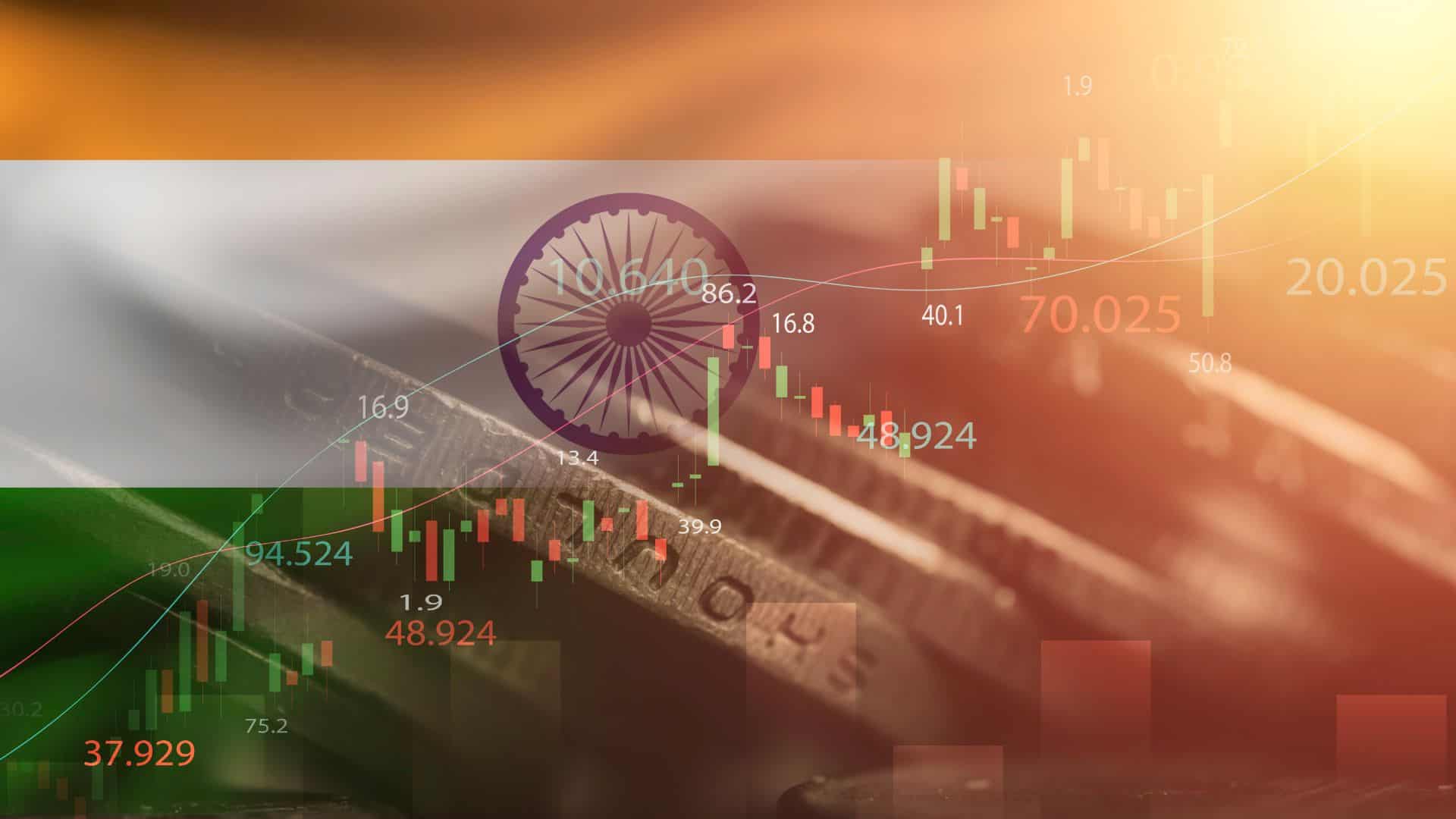 Indian flag overlaying a financial market chart with candlestick graphs and numerical indicators on a coin background